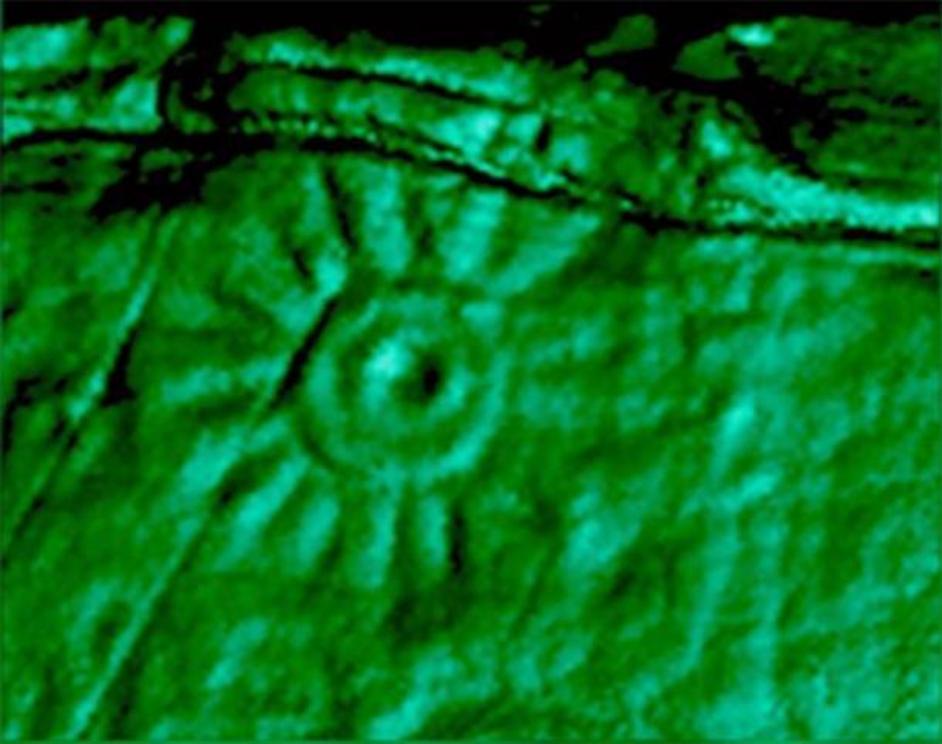 A close-up image of one of the carvings on the Peruvian monolith that was 3D scanned. The engraving has a hole in the centre and lines radiating from the circle.