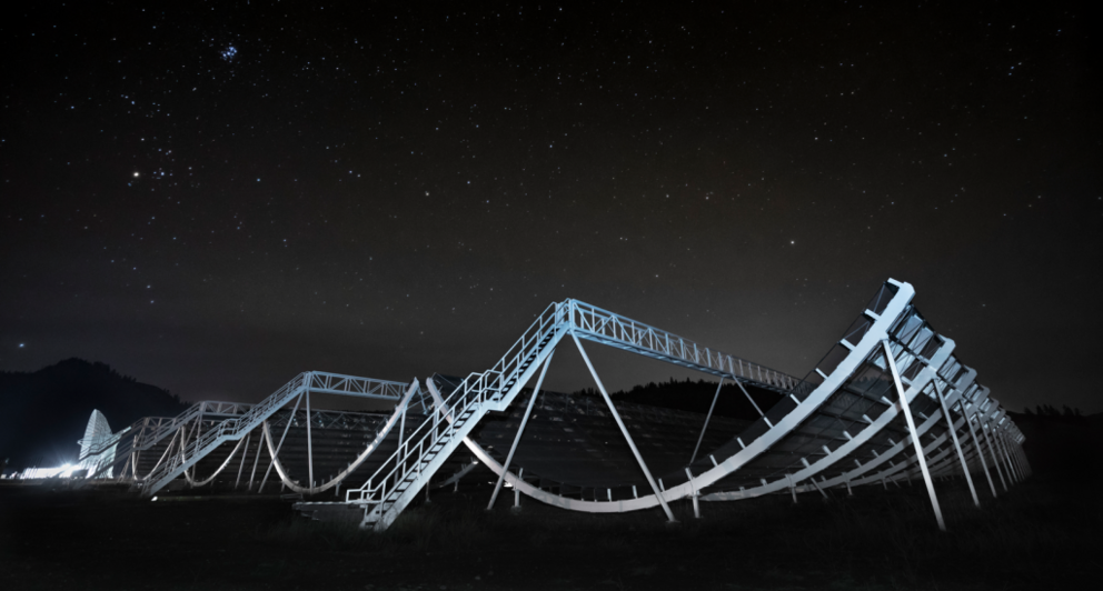 A photo shows the Canadian Hydrogen Intensity Mapping Experiment Fast Radio Burst Project at night.  (Image: © CHIME FRB)