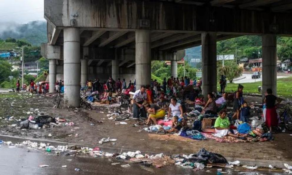 People who were forced to abandon their homes in the in the aftermath of Hurricane Eta take refuge in a makeshift camp underneath an overpass.