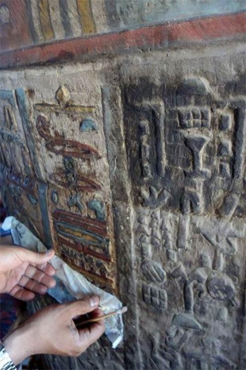 A wall section in the Esna Temple being cleaned.