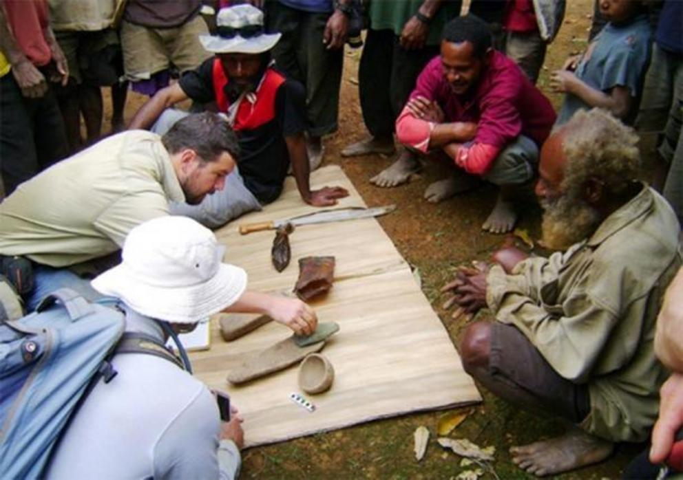 Dr Ben Shaw and some locals examine a few of the Papua New Guinea artifacts unearthed at the Waim dig site in the northern highlands