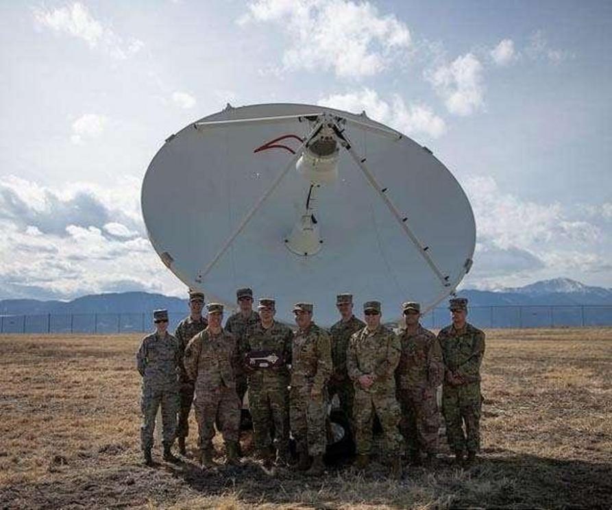 Airmen from the 4th Space Control Squadron take a picture in front of the Counter Communications System Block 10.2 on March 12 on Peterson Air Force Base, Colo. The 4th SPCS received the B10.2 from the Space and Missile Systems Center on Los Angeles Air F