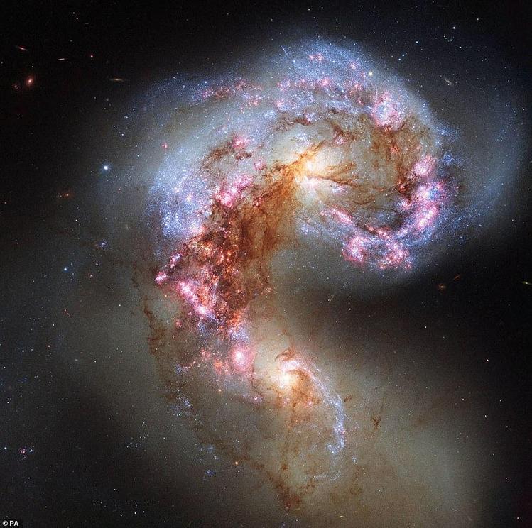 This mage captured by the Hubble Space Telescope shows the Antennae Galaxies also known as NGC 4038 and NGC 4039 which are locked in a deadly embrace. Once normal, sedate spiral galaxies like the Milky Way, the pair have spent the past few hundred million