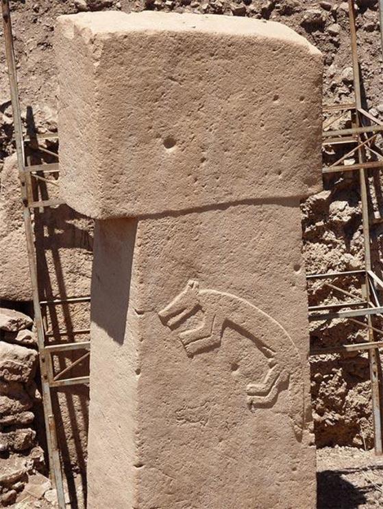 Close-up of a stone pillar at Göbekli Tepe with an intricate relief carving.