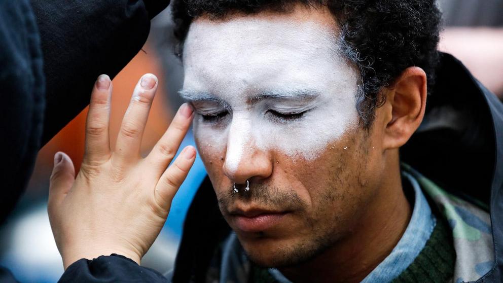 A man, who declined to be identified, has his face painted to represent efforts to defeat facial recognition during a protest at Amazon headquarters over the company’s facial recognition system, “Rekognition,” Oct. 31, 2018, in Seattle. Elaine Thompson | 