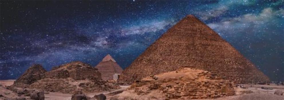The Pyramids of Giza at night time.