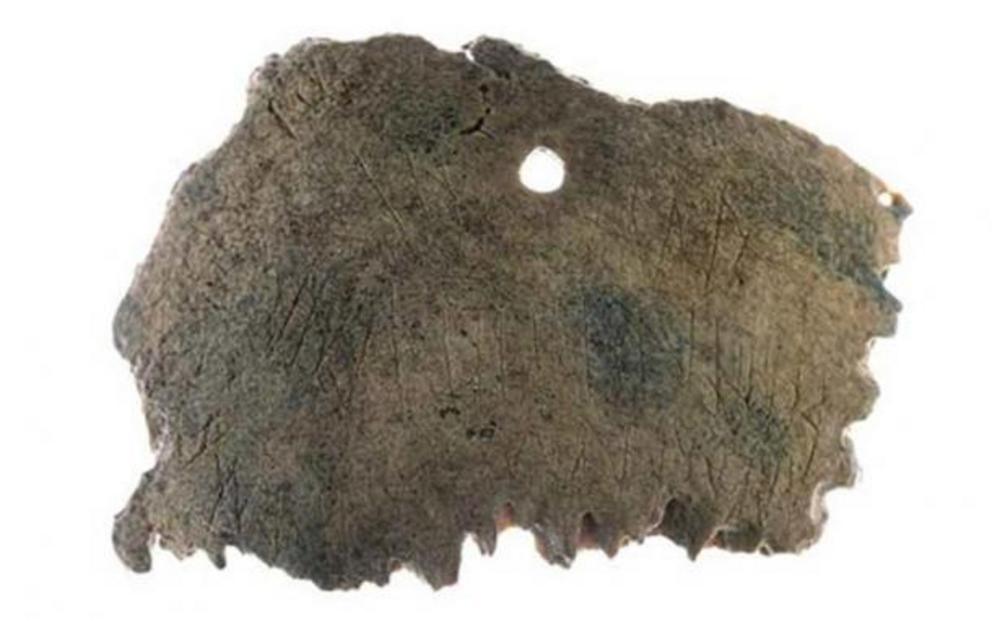 Ribe skull fragment with perforation and runic inscription.