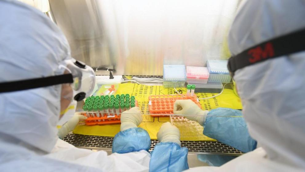 Workers at a laboratory in Wuhan, China. February 2020. © China Daily / Reuters 