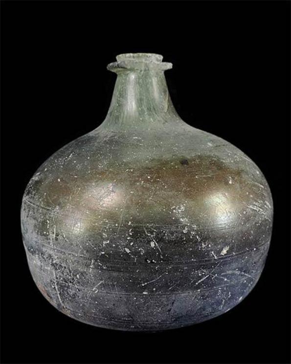 A glass wine bottle dating from 1690-1700 AD.