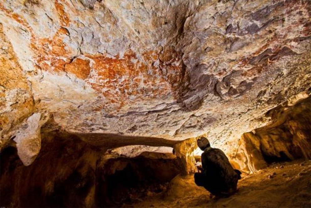 Figurative art, found in a cave in East Kalimantan, Borneo, depicts wild cattle and dates to about 40,000 years ago. Some researchers correlate the position of certain paintings with the position of the stars and the moon.