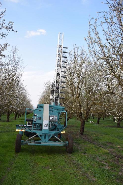 An Edete pollination machine moving through an orchard.