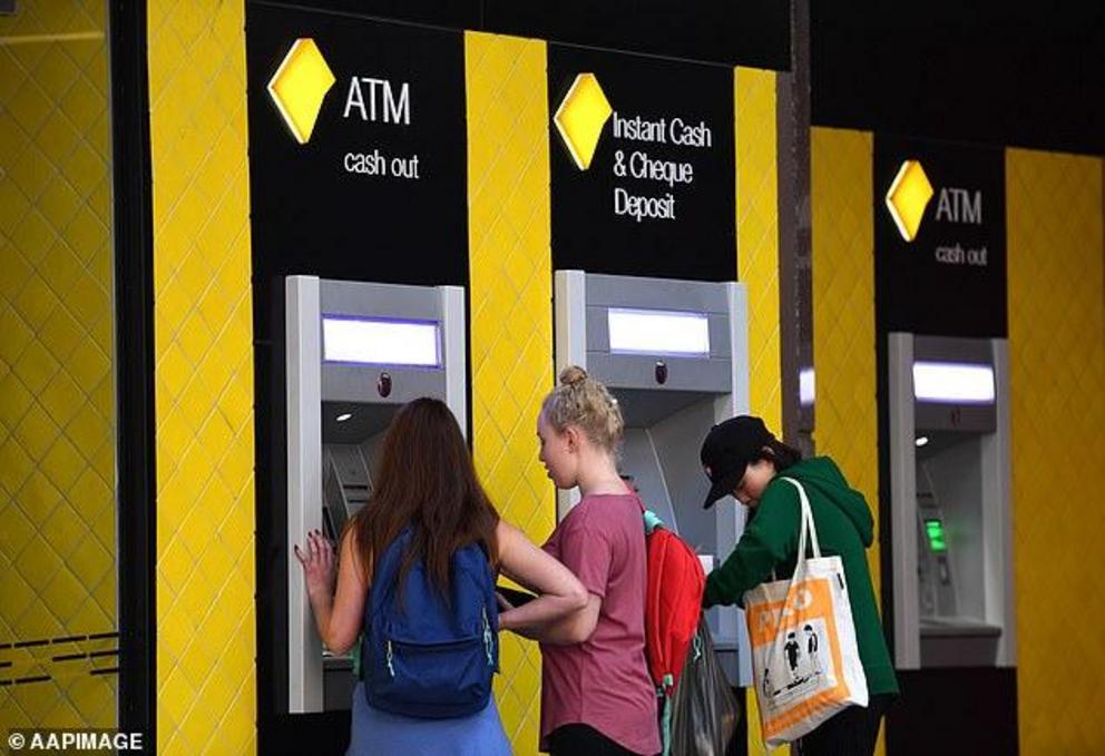 At least 2150 ATM terminals were removed in the June quarters, according to the latest quarter. Pictured are Commonwealth Bank customers withdrawing cash in Brisbane