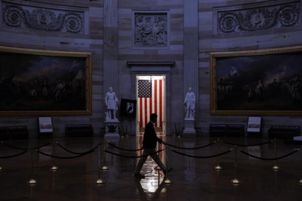 A man walks through the U.S. Capitol Rotunda, empty of tourists as only essential staff and journalists are allowed to work during the coronavirus pandemic, in Washington on March 24. Chip Somodevilla/Getty Images