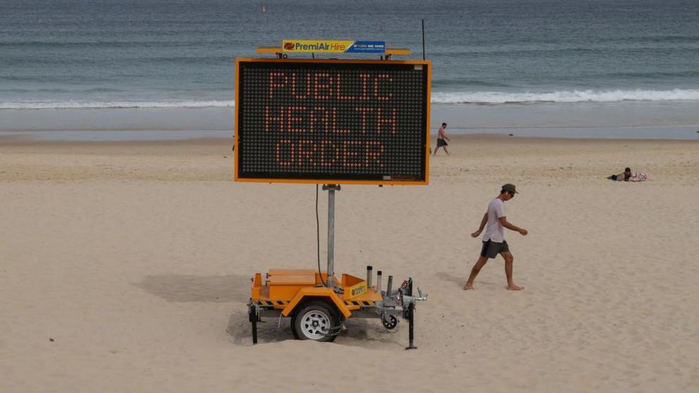 Australian beachgoers being remotely lectured by Big Brother © Reuters / Loren Elliot