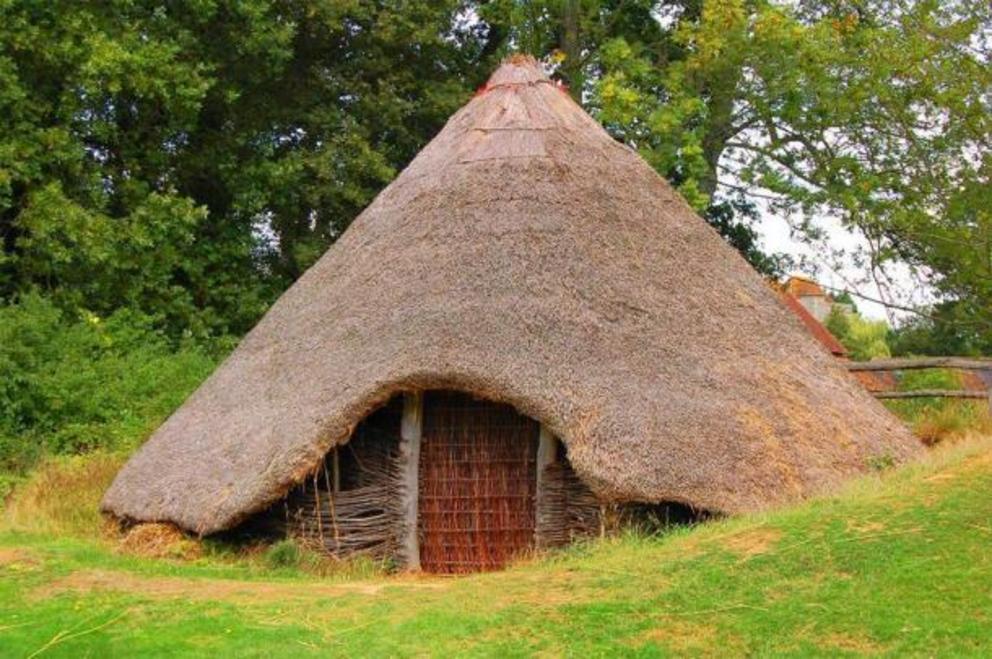 A reconstruction of a British Bronze/Iron Age roundhouse. Sometimes human remains were interred in the houses of the living. 