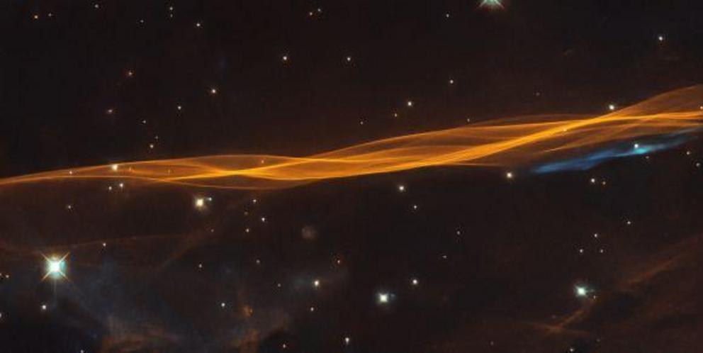 While appearing as a delicate and light veil draped across the sky, this image from the NASA/ESA Hubble Space Telescope actually depicts a small section of the Cygnus supernova blast wave, located around 2600 light-years away.