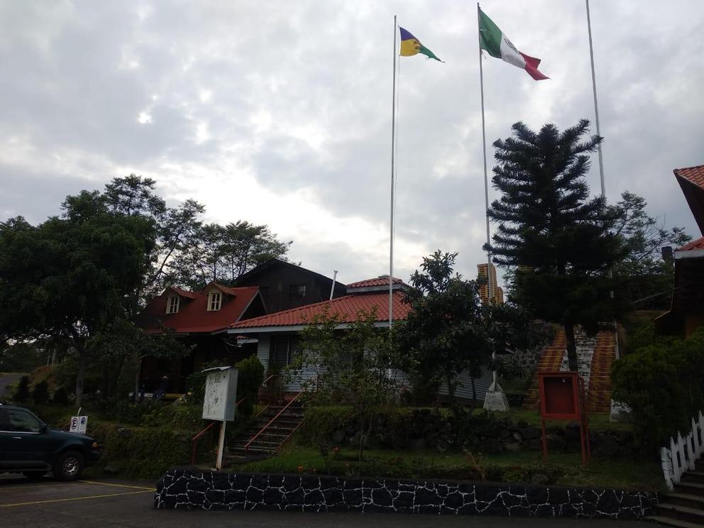 The Purépecha and Mexican flags fly next to each other in the village of Nuevo San Juan Parangaricutiro.