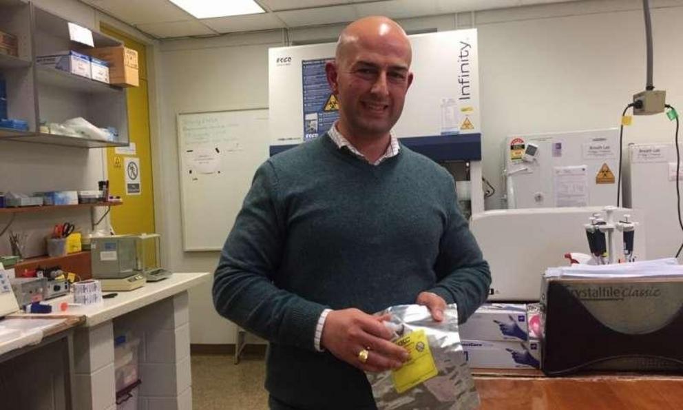 Cancer researcher Dr Roger Yazbek holding a special bag used to collect breath samples. Credit: Flinders University