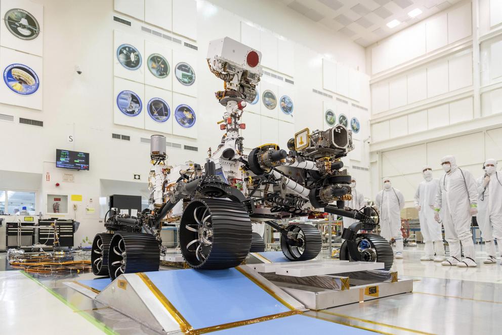 In this Dec. 17, 2019 photo made available by NASA, engineers watch the first driving test for the Mars 2020 rover, later named 