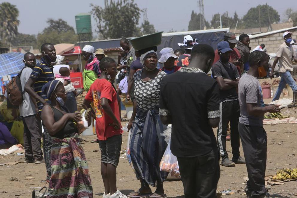 People are seen at a busy market in a poor township on the outskirts of the capital Harare, Monday, Nov, 15, 2021. When the coronavirus first emerged last year, health officials feared the pandemic would sweep across Africa, killing millions and destroyin
