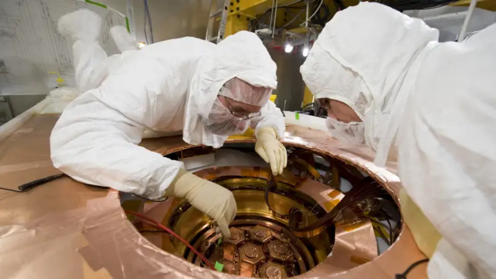 Two scientists at the Fermilab in Batavia, Illinois, working on a muon detector.