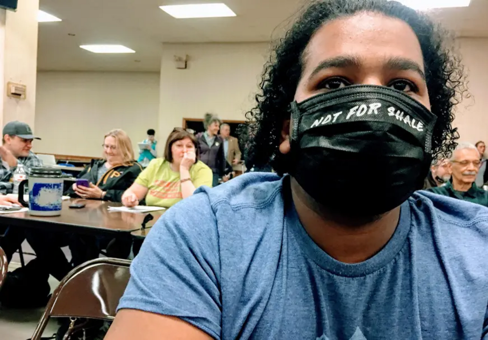 An activist wears a face mask to protest poor air quality caused by fracking, pre-COVID-19, at a 2019 community meeting in Braddock, Pennsylvania.