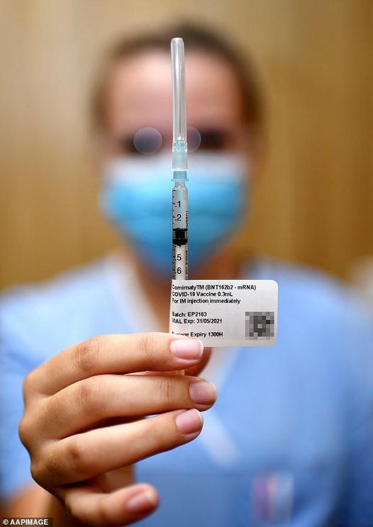 Pictured: A nurse holding up a Covid vaccine at Metro North Health facility in Brisbane on March 1