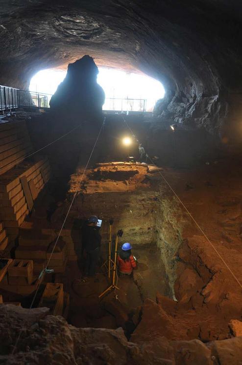 Archaeologists working inside of Wonderwerk Cave.