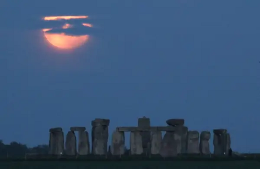 The full moon seen behind Stonehenge in England on May 26.