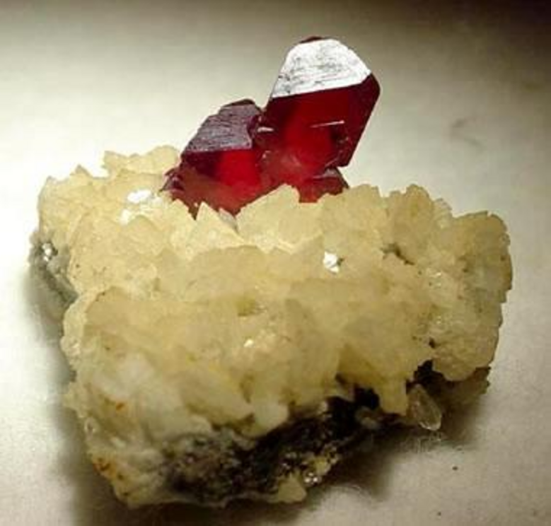 Cinnabar crystals: Bright red cinnabar crystals on a dolomite matrix. Crystals are about 1.3 centimeters in height, from Hunan, China.