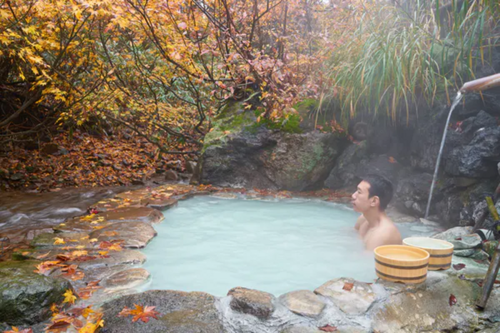 A man enjoys the hot spring at Nyuto Onsen, Tohoku, Japan.