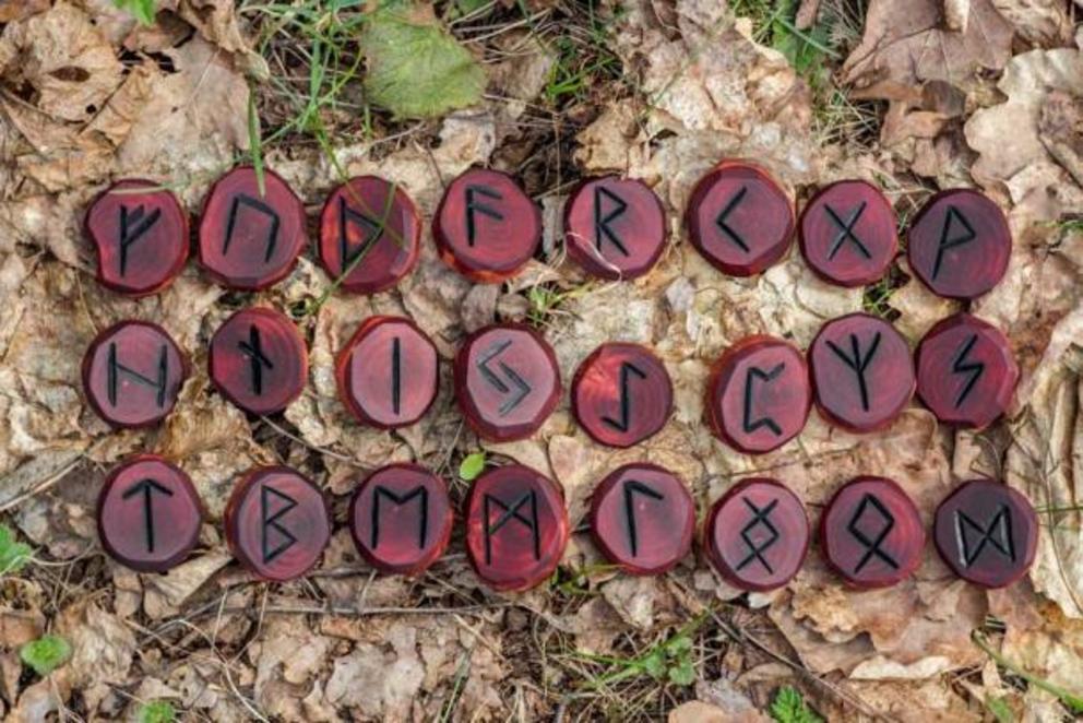 Norse or Viking runic letters, known as Elder Futhark, on red wooden discs and you can immediately recognize letters from our modern alphabet.