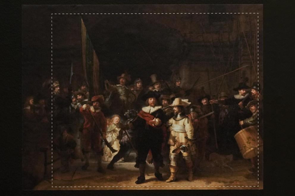 A photograph with lines showing the added parts explains how Rembrandt's biggest painting the Night Watch just got bigger with the help of artificial intelligence in Amsterdam, Netherlands, Wednesday, June 23, 2021. The Dutch national museum and art galle