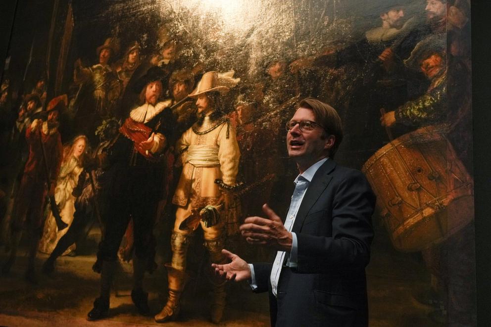 The added part of the painting is seen right as Rijksmuseum director Taco Dibbits explains how Rembrandt's biggest painting the Night Watch just got bigger with the help of artificial intelligence in Amsterdam, Netherlands, Wednesday, June 23, 2021. The D