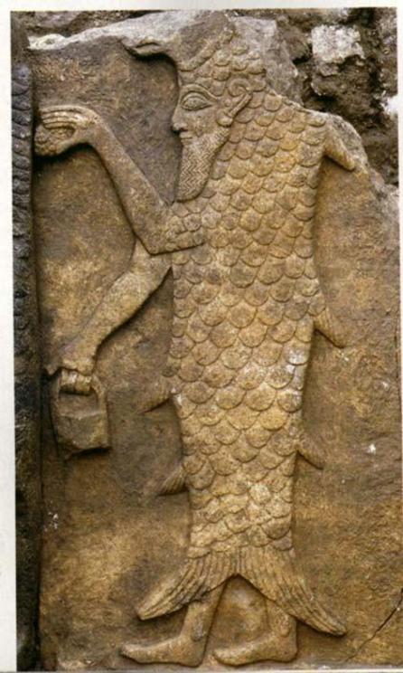 Androgynous Babylonian man-fish deity Oannes carrying the mysterious “man bag”.