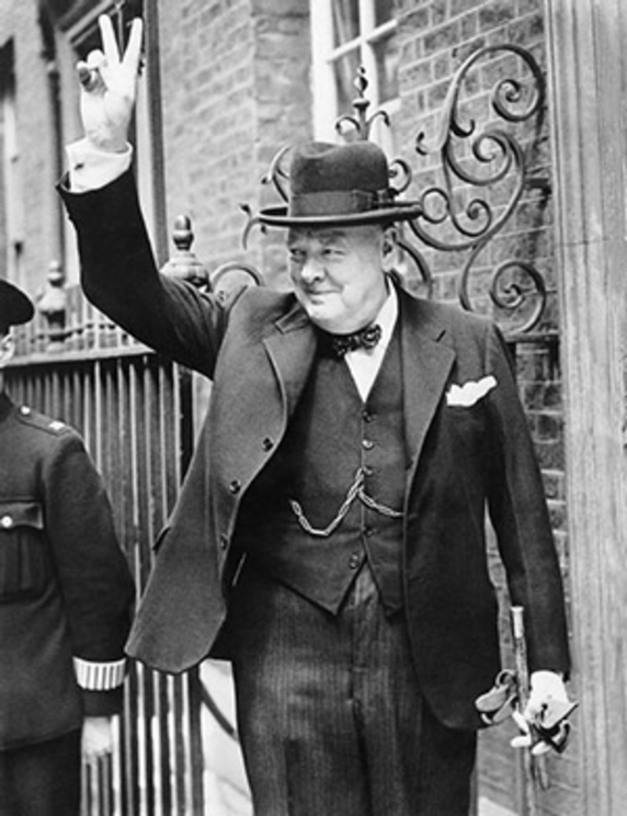 Winston Churchill makes the V for Victory sign. 