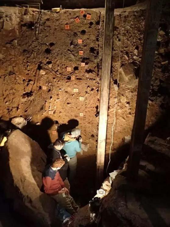 Researchers Zenobia Jacobs, Bo Li and Kieran O'Gorman collecting soil samples in the main chamber to test for Denisova Cave DNA.