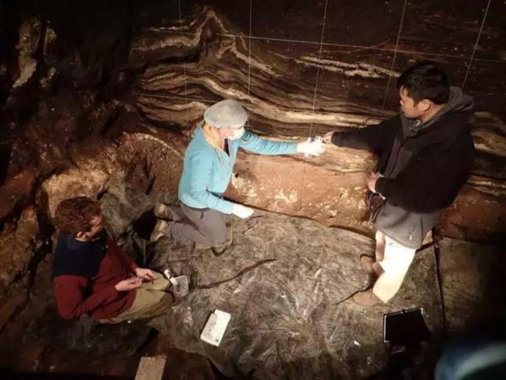 Researchers Zenobia Jacobs, Bo Li and Kieran O'Gorman in the south chamber of the cave taking sediment samples as they search for more Denisova Cave DNA.