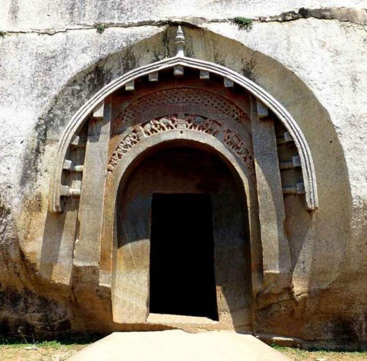 The famous carved entrance of the Lomas Rishi Cave, one of the Barabar Caves in Bihar, India, featuring the oldest chaitya arch in India.