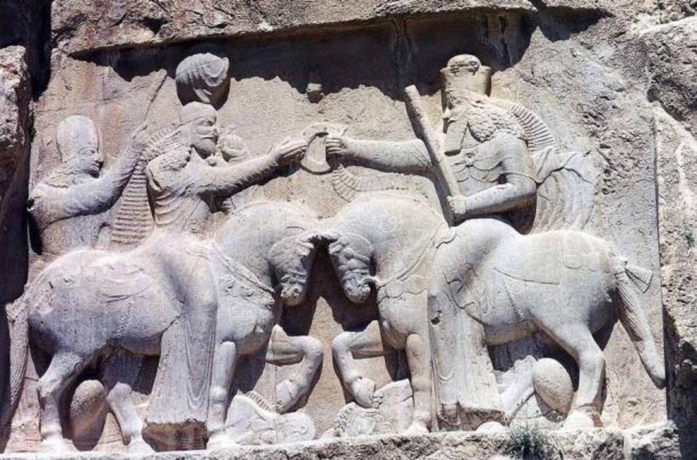 A relief at Naqsh-e Rustam in modern-day Iran showing Ardashir I and an unidentified cavalier. This Persian rock relief depicts Ardashir I's coronation scene, as the first king of the Sassanid Empire of Iran. Ardashir I receives the cydaris ring of power,