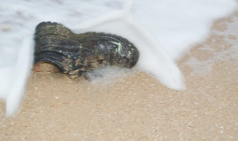 A stock image of a shoe washing up on a beach. Getty Images