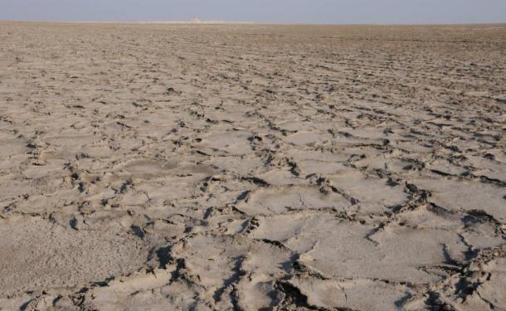 The ‘Great River’ close up: in reality the sabkha is a dirty brown mush of salt and sand, very different from desert sand.