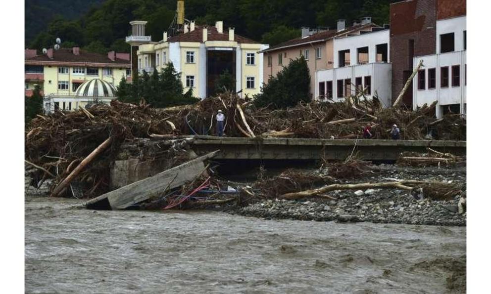 A man watches the destruction after floods and mudslides killed about three dozens of people, in Bozkurt town of Kastamonu province, Turkey, Friday, Aug. 13, 2021.