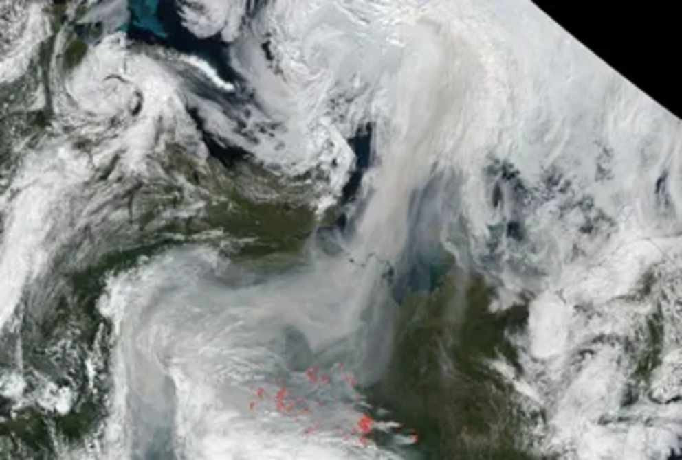 A satellite image shows fire hot spots and smoke stretching from Russia to the North Pole on Aug. 2, 2021.