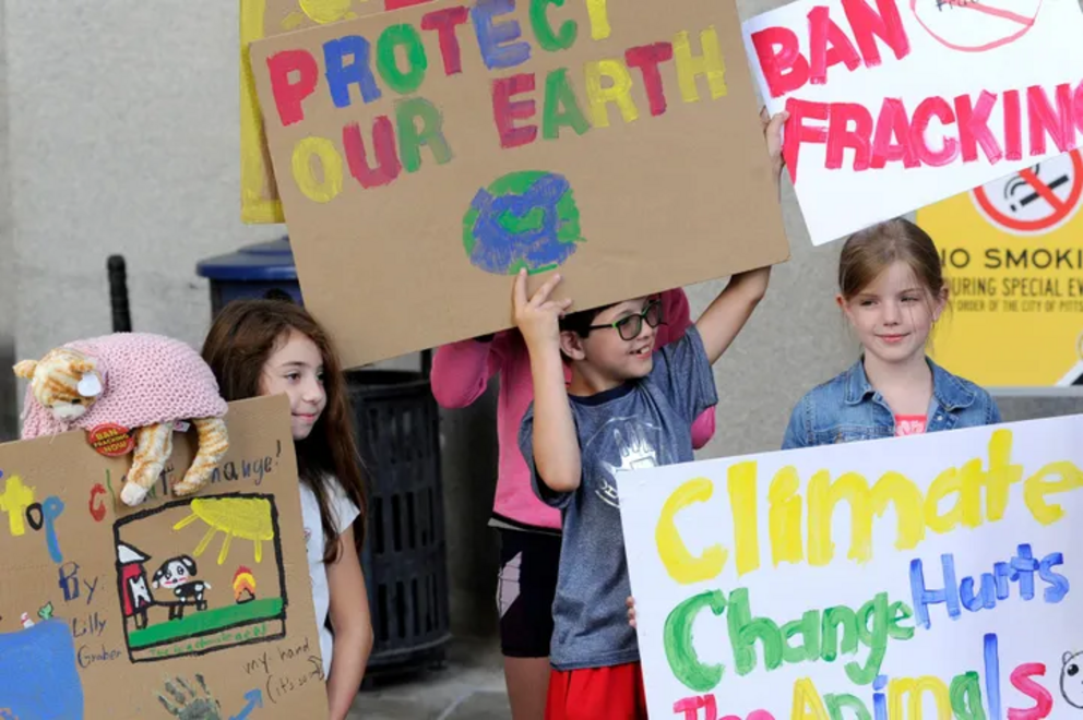 Children from two families involved in EHN's study participate in a 2019 youth climate change protest in downtown Pittsburgh.