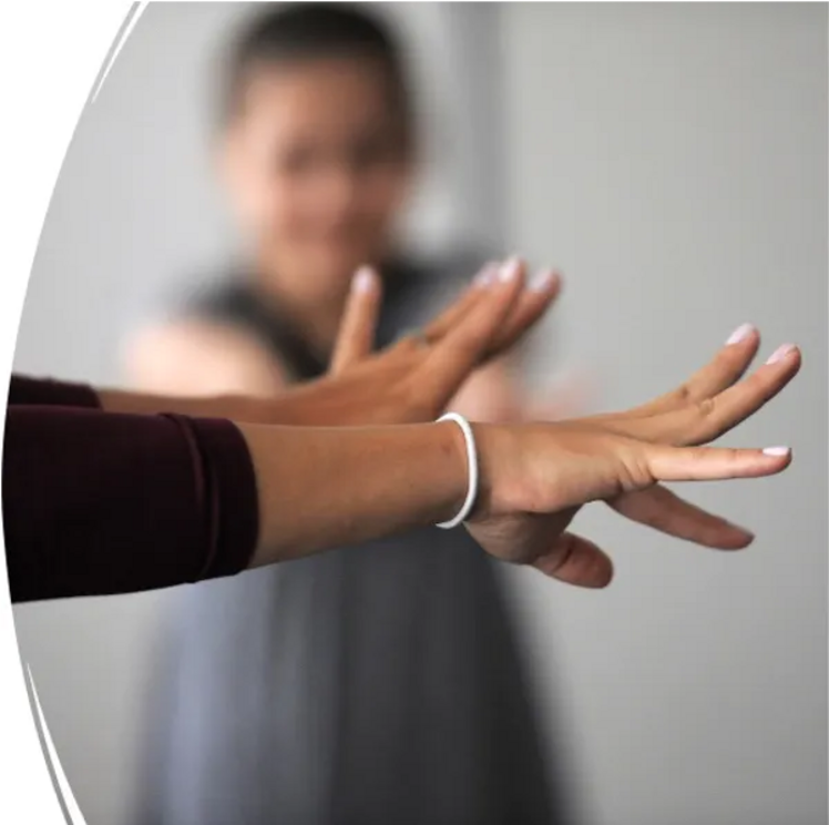 With outstretched arms, neuroscientist Lana Ruvolo Grasser performs a tension-and-release exercise with her study participants.