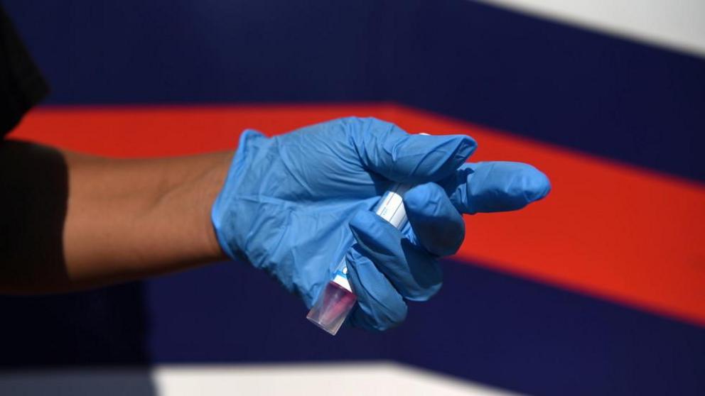 File photo: A healthcare worker holds a completed Covid-19 test sample in Houston, Texas, August 16, 2021. ©  REUTERS/Callaghan O'Hare