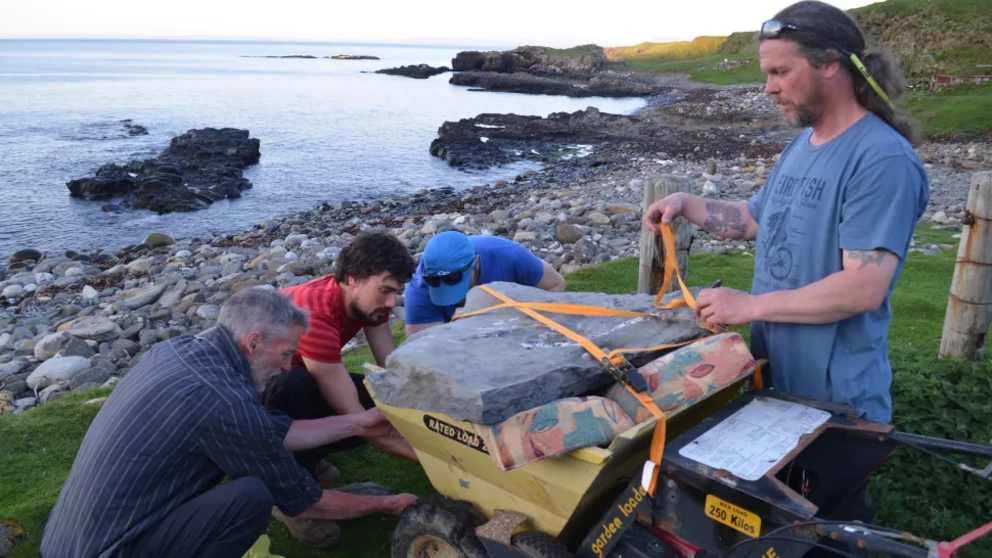 The research team secures the fossil slab so it can be transported to the lab.