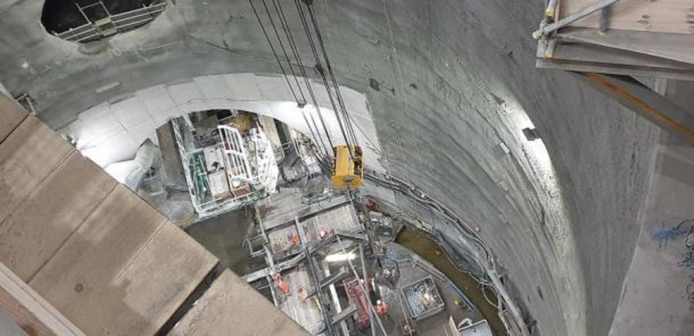 A picture of the back of the Thames Tideway Tunnel Boring Machine Rachel named after Rachel Parsons. The machine is 90 meters or 295 feet long. The image shows the shaft down to the Thames Tideway Tunnel, the tunnel opening, a smaller tunnel connecting to