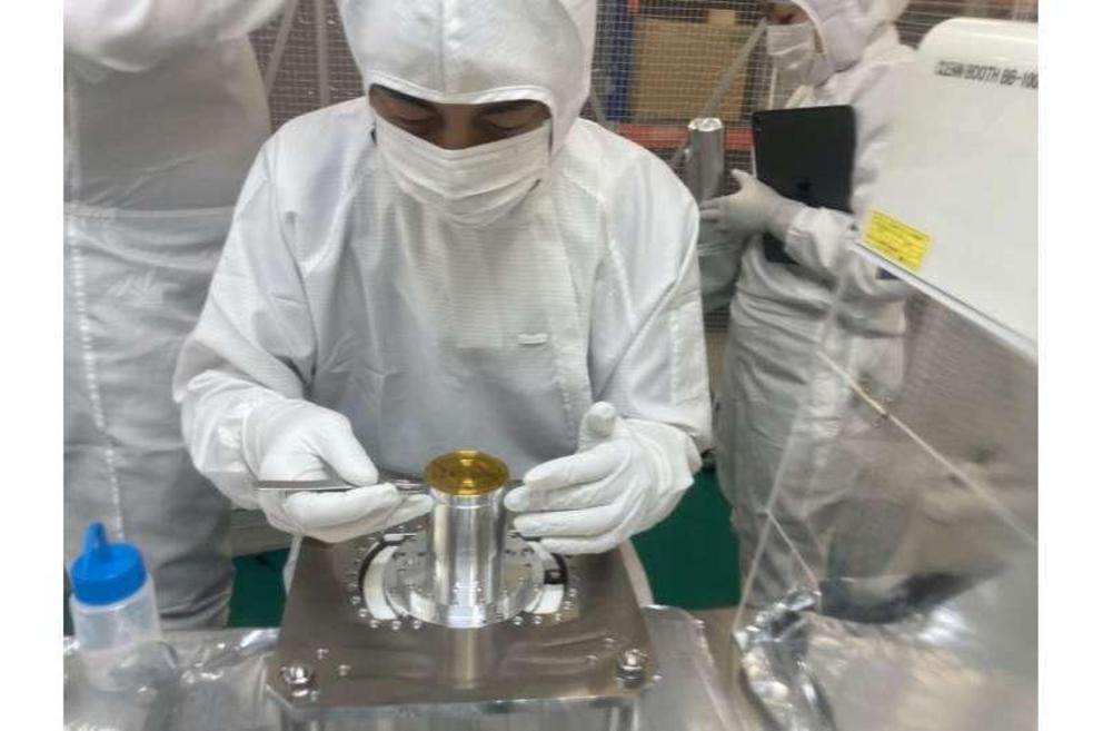 Scientists preparing the sample capsule for analysis.